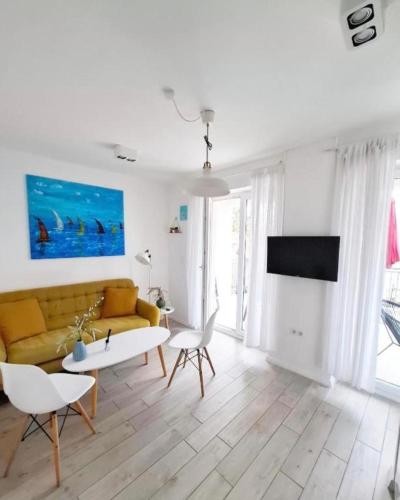 a living room with a couch and a table and chairs at Vila Dida Suites City Centar in Split
