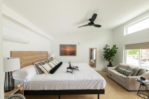 a bedroom with a large bed and a couch at The Waypoint in Rehoboth Beach