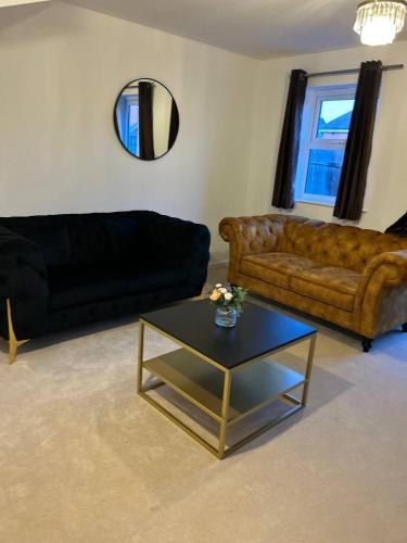 a living room with a couch and a coffee table at Stunning 2BR house in Colchester in Colchester