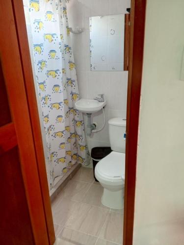 a small bathroom with a toilet and a sink at Hotel El Balcon de madera in Norcasia