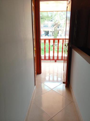 an open door with a view of a balcony at Hotel El Balcon de madera in Norcasia