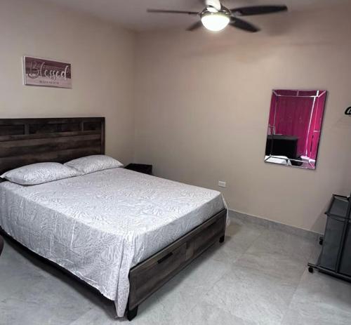 a bedroom with a bed and a ceiling fan at THE NEST Studio Apartment in Philipsburg