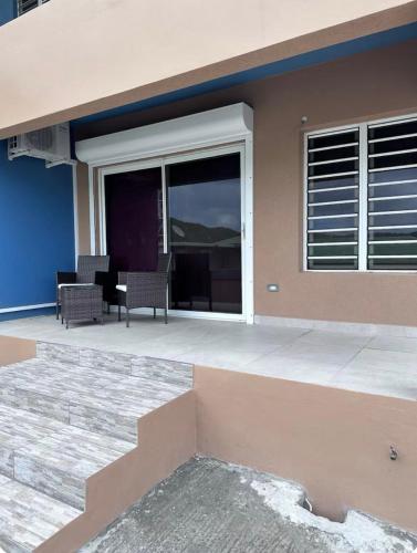 a house with a patio with a table and chairs at THE NEST Studio Apartment in Philipsburg