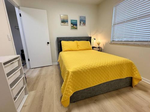 a bedroom with a bed with a yellow bedspread at Blessed Beyond Measure King with Ensuite in Norwalk