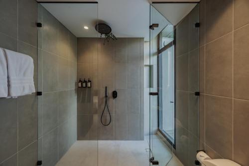 a bathroom with a shower with a glass door at Seissta Medellín in Medellín