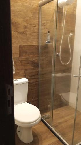 a bathroom with a toilet and a glass shower at Sobrado PEREIRA E LOBATO in Belém