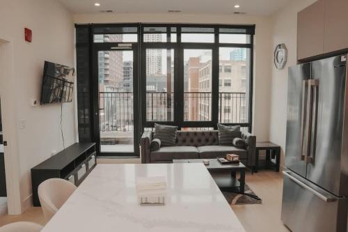 a kitchen and living room with a couch and a refrigerator at River North Private Balcony With In and Out Parking in Chicago
