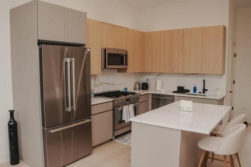 a kitchen with a stainless steel refrigerator and cabinets at River North Private Balcony With In and Out Parking in Chicago