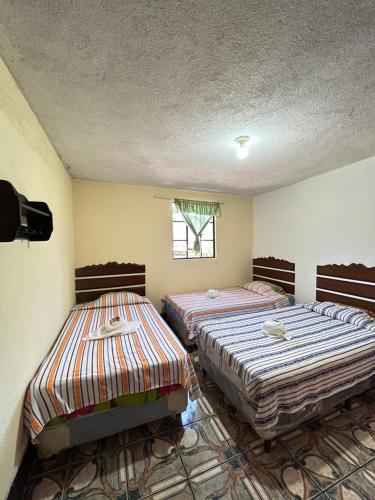 Una cama o camas en una habitación de Hotel Tepepul Kaan