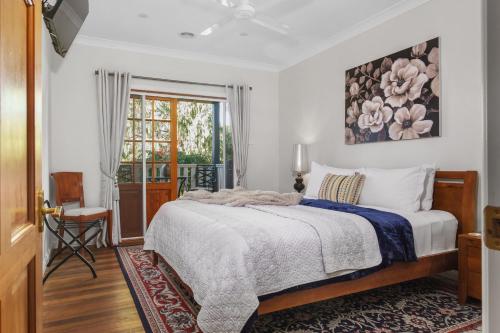 a bedroom with a bed and a window at Little Chelsea in Moss Vale