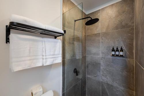 a bathroom with a shower with a glass door at Raices Nomadas Boutique Hotel Vallarta in Puerto Vallarta