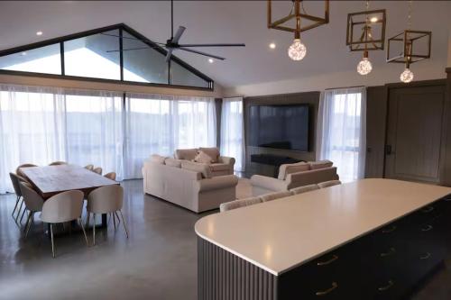 a living room with a couch and a table at Happy Stays Braidwood in Braidwood