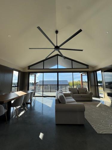 a living room with a large chandelier hanging from the ceiling at Happy Stays Braidwood in Braidwood