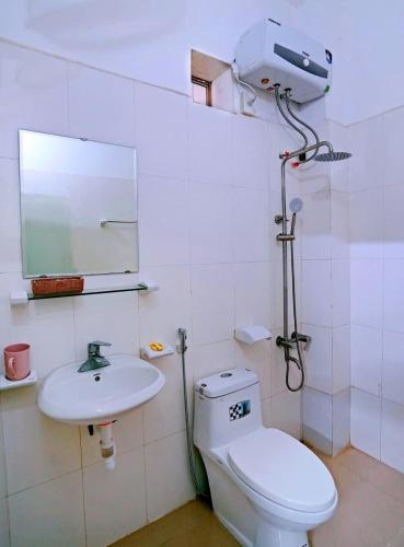 a bathroom with a toilet and a sink at Ninh Binh Alisa Hotel in Ninh Binh