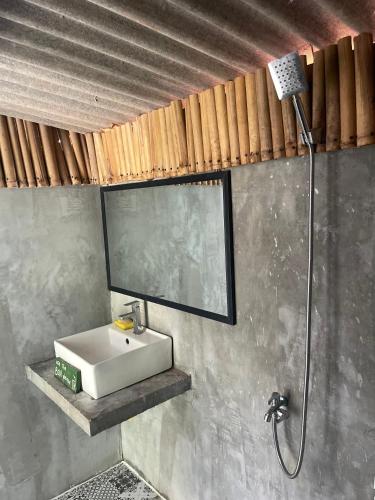 a bathroom with a sink and a shower at The Bear Bungalow in Kampot