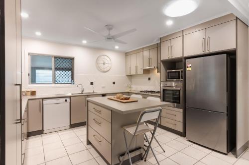 a kitchen with a stainless steel refrigerator and a counter at Gobie Getaway in Kurrimine Beach