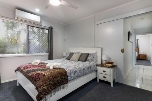 a bedroom with a large bed and a window at Gobie Getaway in Kurrimine Beach