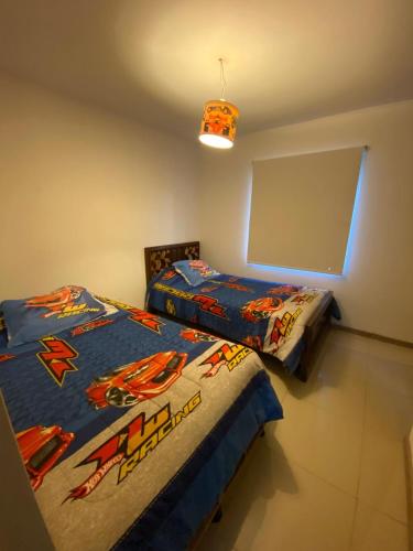 two beds sitting next to each other in a room at Casa lago rapel in Lago Rapel