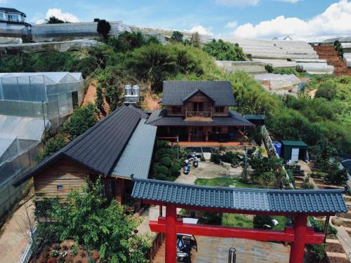 a model of a house on top of a hill at Nhà Gỗ Chân Nguyên Villa in Ấp Ða Lôc