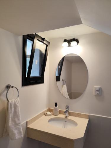 a bathroom with a sink and a mirror at Casa del Algarrobo in Cafayate