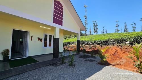 a house on a hill next to a field at Beverly Hills Vagamon in Vagamon