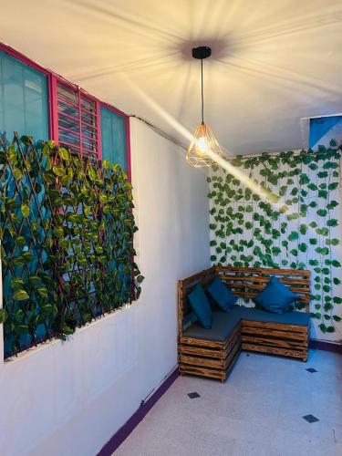 a room with a couch in front of two windows at Casa Almanik Hostel in Medellín