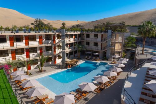 an aerial view of a hotel with a pool and umbrellas at Senoma Hotel - Adults only in Ica