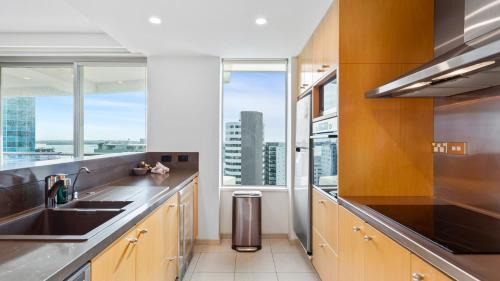 a kitchen with a sink and a large window at QV Stays Upscale Urban Sanctuary in Auckland