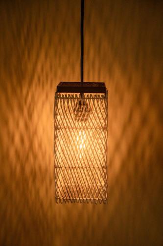 a lamp hanging from a wall at Masaya Retreat Lombok in Kuta Lombok