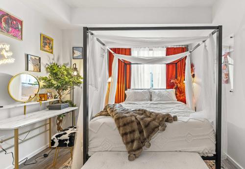 a bedroom with a canopy bed and a desk at Central Boston Two-Bedroom Two-Bath Suite in Boston