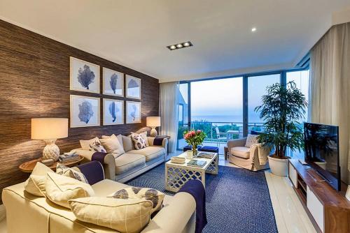 a large living room with couches and a television at Ocean View Penthouse 1326 at Bells Boulevard in Kingscliff
