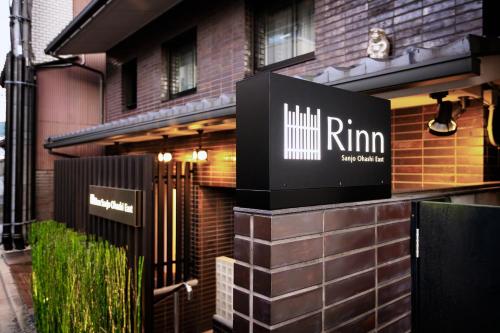 a building with a sign on the side of it at Rinn Sanjo Ohashi East in Kyoto
