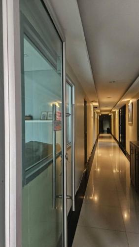 a hallway in a building with a sign on the door at สุวรรณภูมิอพาร์ทเม้นท์ in Suvarnabhumi Airport