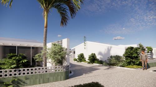 Una representación del exterior de un edificio con una palmera. en The Monty, en Anglesea