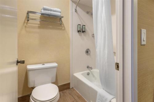 a bathroom with a white toilet and a bath tub at Best Western Inn Santa Clara in Santa Clara