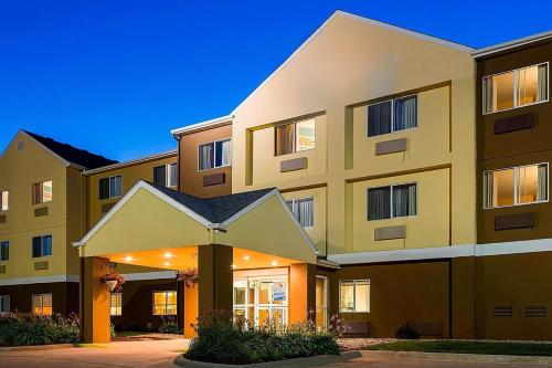 a large apartment building with a building at Wingate by Wyndham Oshkosh in Oshkosh