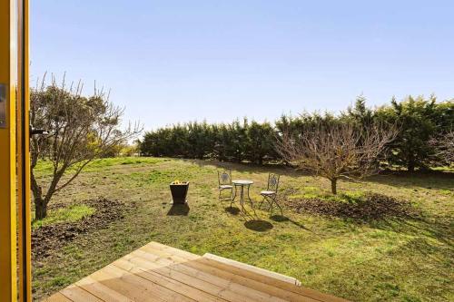 a patio with a table and chairs in a yard at Tiny in the Orchard by Tiny Away in Windermere