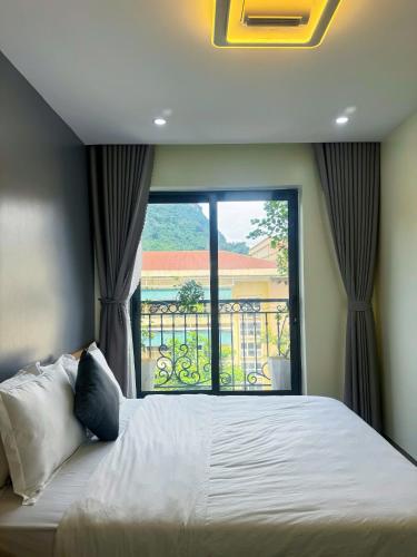 a bedroom with a large bed and a window at Sky Hotel & Homestay Ha Giang in Ha Giang