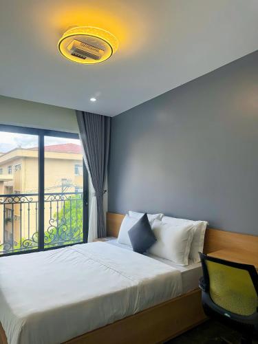 a bedroom with a large bed and a window at Sky Hotel & Homestay Ha Giang in Ha Giang