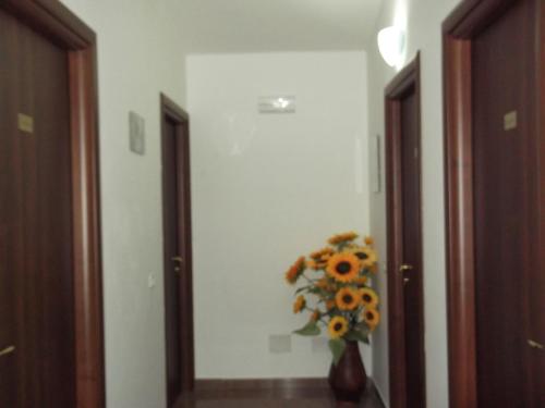 a vase of sunflowers is sitting in a hallway at B&B Da Rosa Camerota in Camerota