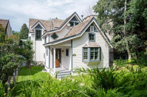 a white house with a roof at Spacious Designer 3BR Victorian with AC & Hot Tub in Aspen