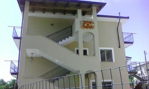 a building with a staircase on the side of it at B&B Da Rosa Camerota in Camerota