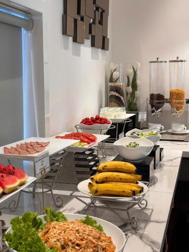 a buffet with many plates of food on a table at 22 Land Hotel in Hanoi