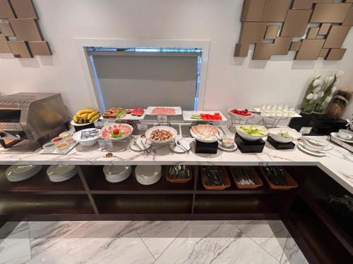 a buffet line with many different types of food at 22 Land Hotel in Hanoi