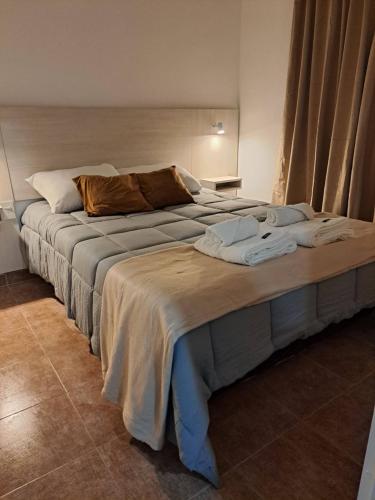 a bedroom with two beds with towels on it at Apart Milo II in San Fernando del Valle de Catamarca