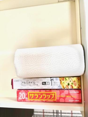 a stack of books in an open refrigerator at 古民家ｓｔｙｌｅ富山駅東 in Toyama