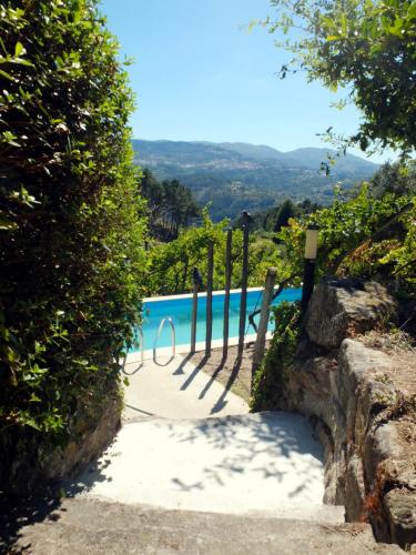 a path leading to a pool with a fence at Family Secrets Douro in Riba Douro