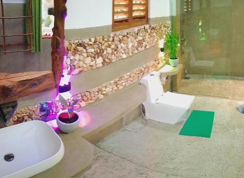 a bathroom with a white sink and a toilet at Serenity cottage in Ella