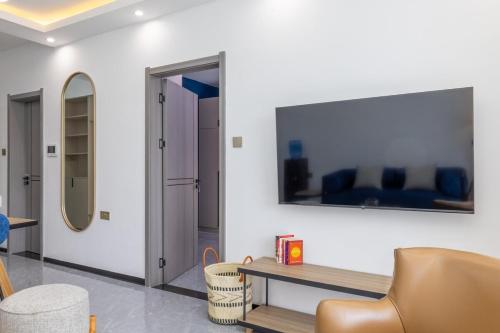 a living room with a couch and a mirror at Nandwa Ivy By YourHost, Kileleshwa, Nairobi in Nairobi