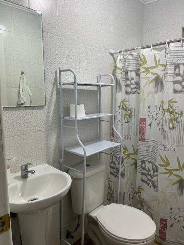 a bathroom with a toilet and a sink at Cabañitas Zelada in Algarrobo